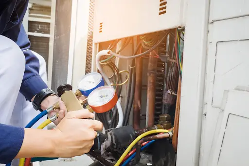 Tempo Air technician performing air conditioner inspection.