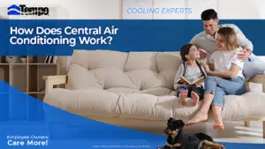 Man holding wife and kid as they relax on the couch with dog by their feet.